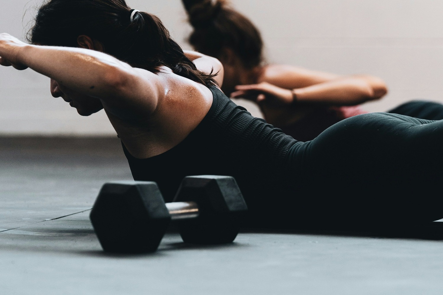 Two women doing floor back extensions